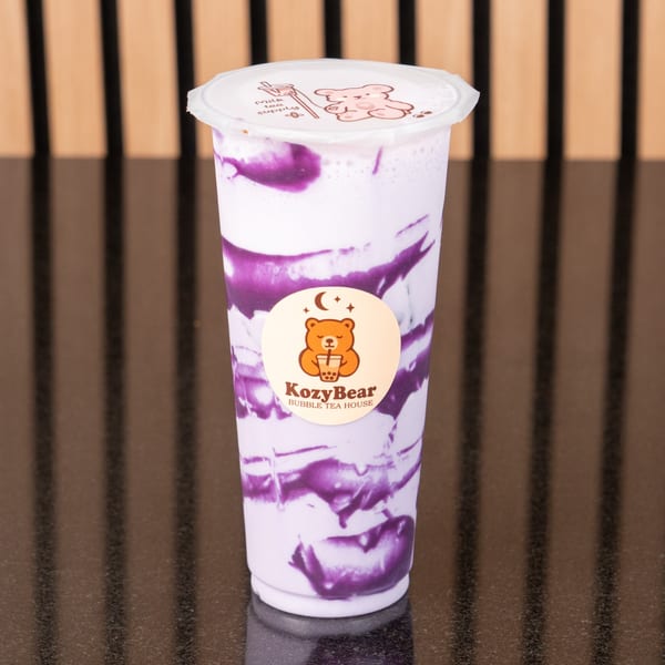A KozyBear Bubble Tea House taro milk tea with purple swirls in a clear cup.
